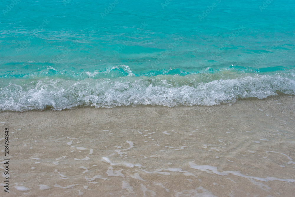 Waves breaking on a sandy beach in the Maldives Islands