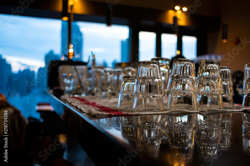 Row of drink glasses on bar countertop selective focus background © danielskyphoto