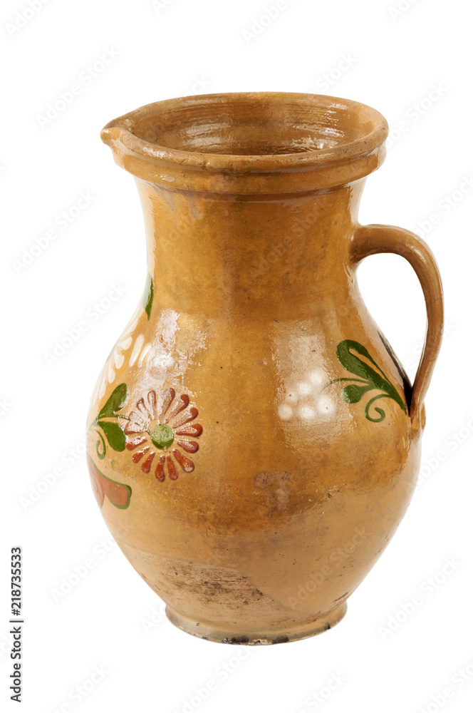 Ceramic crockery. Old traditional Ukrainian brown jar with one handle and geometric pattern isolated on white background.