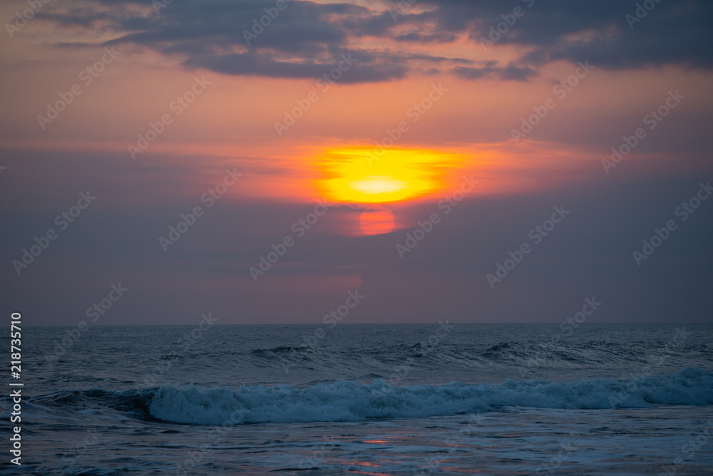 Fototapeta premium beautiful sunset over the sea wave ,in Bali Indonesia