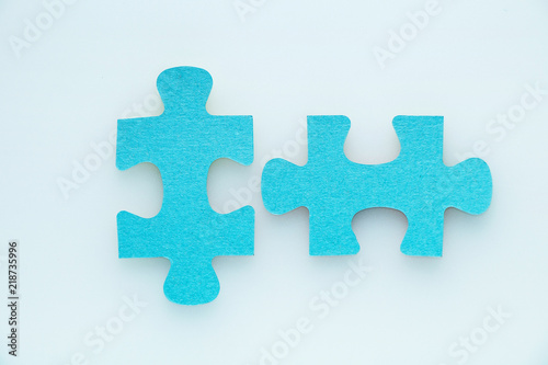 Two pieces of a puzzle piece on a white background.