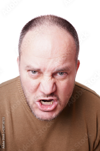 middle aged man with a mad expression on his face shouting 