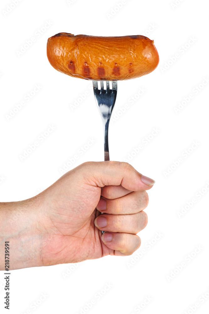 Hand hold grilled sausage on fork Hand hold grilled sausage on fork