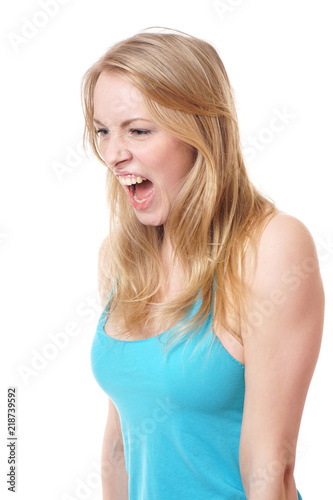 side view of a furious young woman screaming and looking down 
