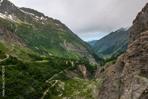 Scenic view of beautiful landscape in Swiss Alps. Fresh green meadows and snow-capped mountain tops in the background in springtime, Switzerland.