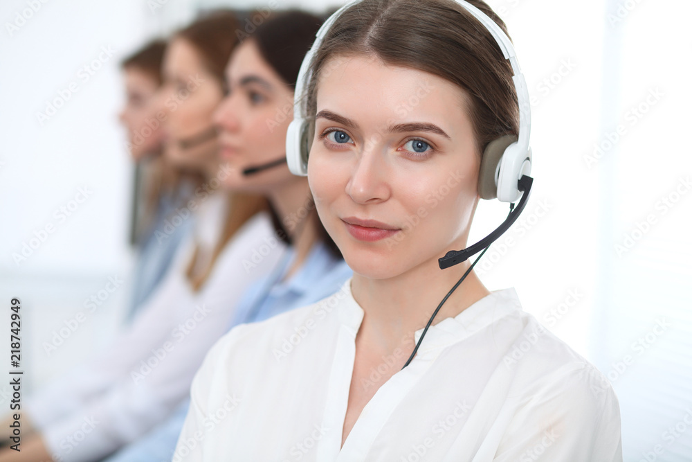 Call center. Beautiful cheerful smiling operator consulting clients with headset. Business concept of customer service