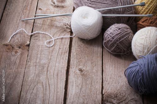 Knitting and knitting needles on a wooden surface