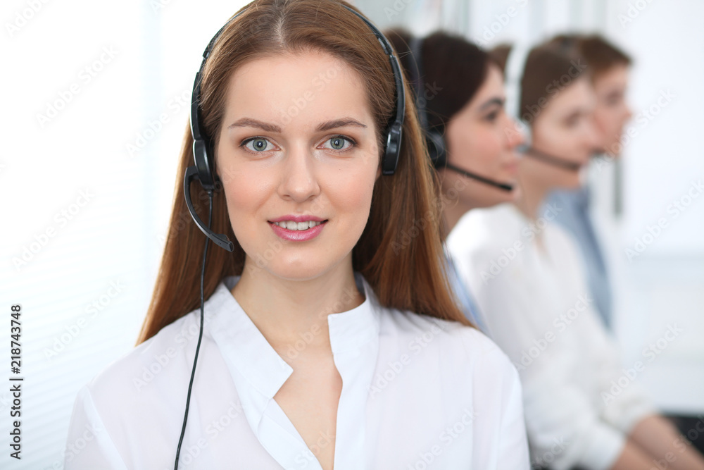 Call center. Beautiful cheerful smiling operator consulting clients with headset. Business concept of customer service