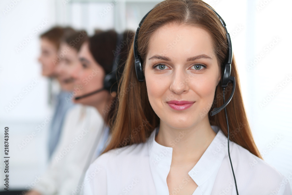 Call center. Beautiful cheerful smiling operator consulting clients with headset. Business concept of customer service