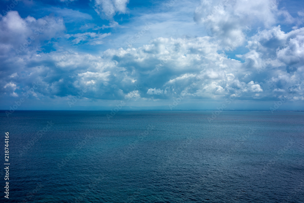 ocean water with blue sky and clouds, full frame