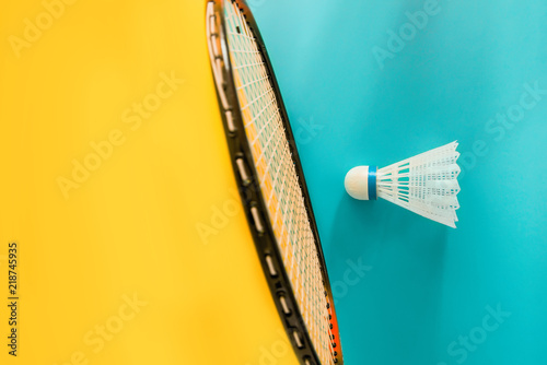 Photography Volant and racket for playing badminton on yellow background