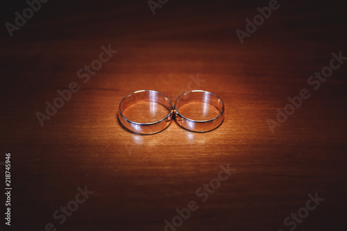 wedding rings on a wooden table