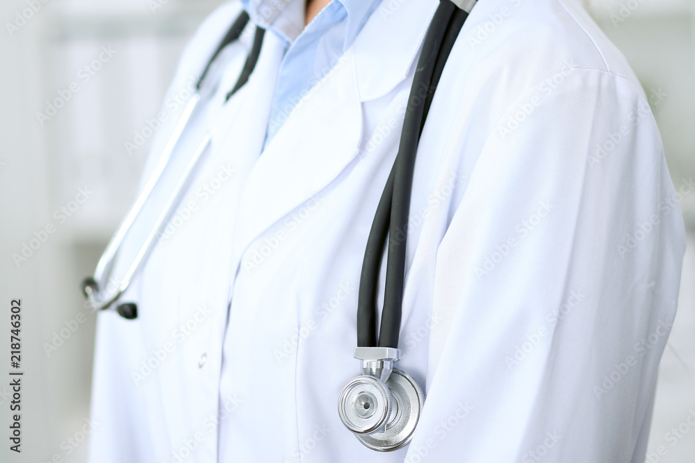 Doctor woman working at hospital. Closeup of stethoscope. Health care, insurance and help concept Doctor woman working at hospital. Closeup of stethoscope. Health care, insurance and help concept