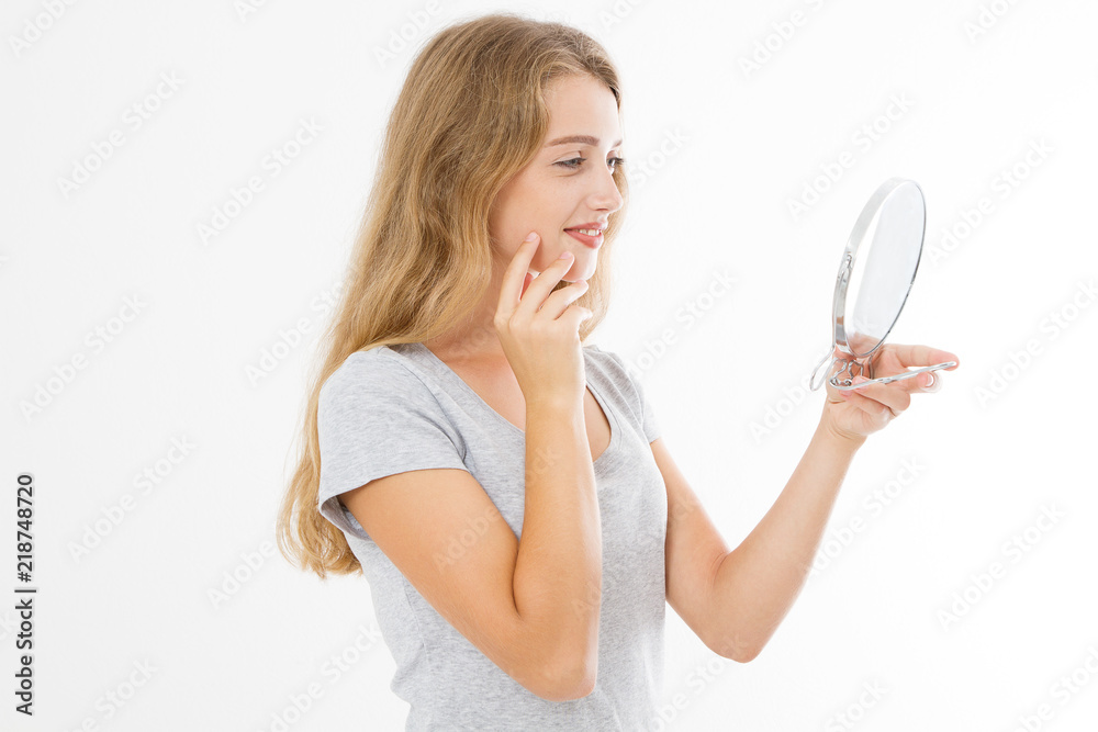 Young caucasian blonde woman looking wrinkles on face in mirror isolated on white background. Skin care and makeup concept. Copy space Young caucasian blonde woman looking wrinkles on face in mirror isolated on white background. Skin care and makeup concept. Copy space