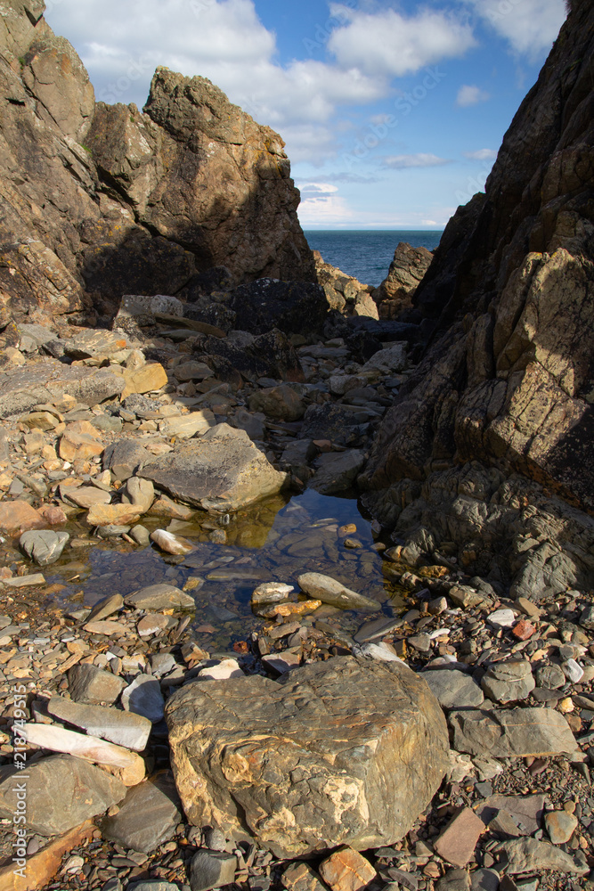 The rocky shoreline at Burrowhead, Scotkand The rocky shoreline at Burrowhead, Scotkand