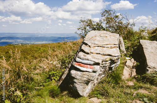 Fototapeta Naklejka Na Ścianę i Meble -  Hiking trail sign panted on the rock in mountains