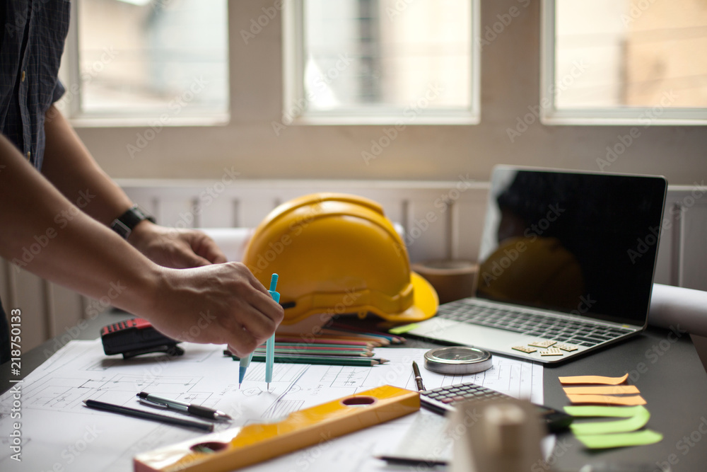 Architects are working with computers and drawing tools , Engineering