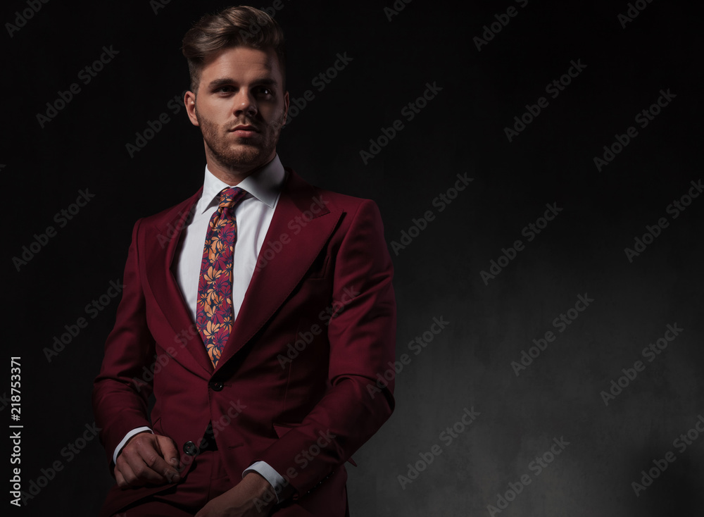 portrait of handsome stylish man in red suit sitting portrait of handsome stylish man in red suit sitting