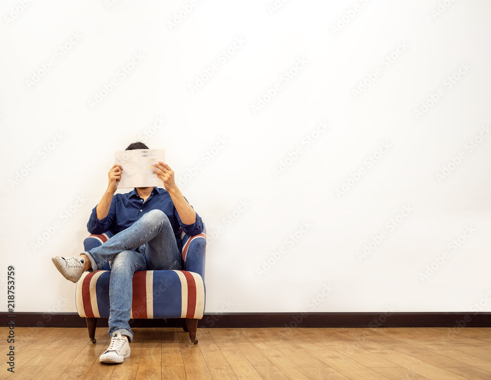 Man reading and sitting on sofa Man reading and sitting on sofa