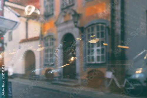 Reflection of the city in the glass of the shoe store