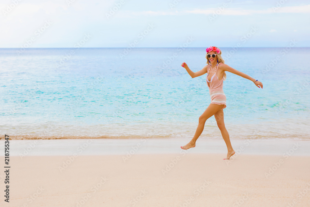 Happy woman walking by the ocean