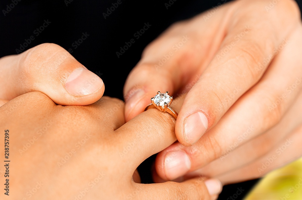 Close up Groom Putting the Wedding Ring on bride Close up Groom Putting the Wedding Ring on bride