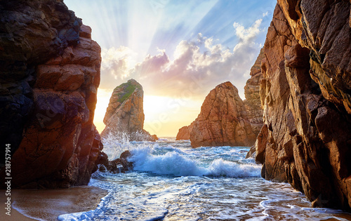 Sand beach among rocks on evening sunset. Ursa near Cape Roca