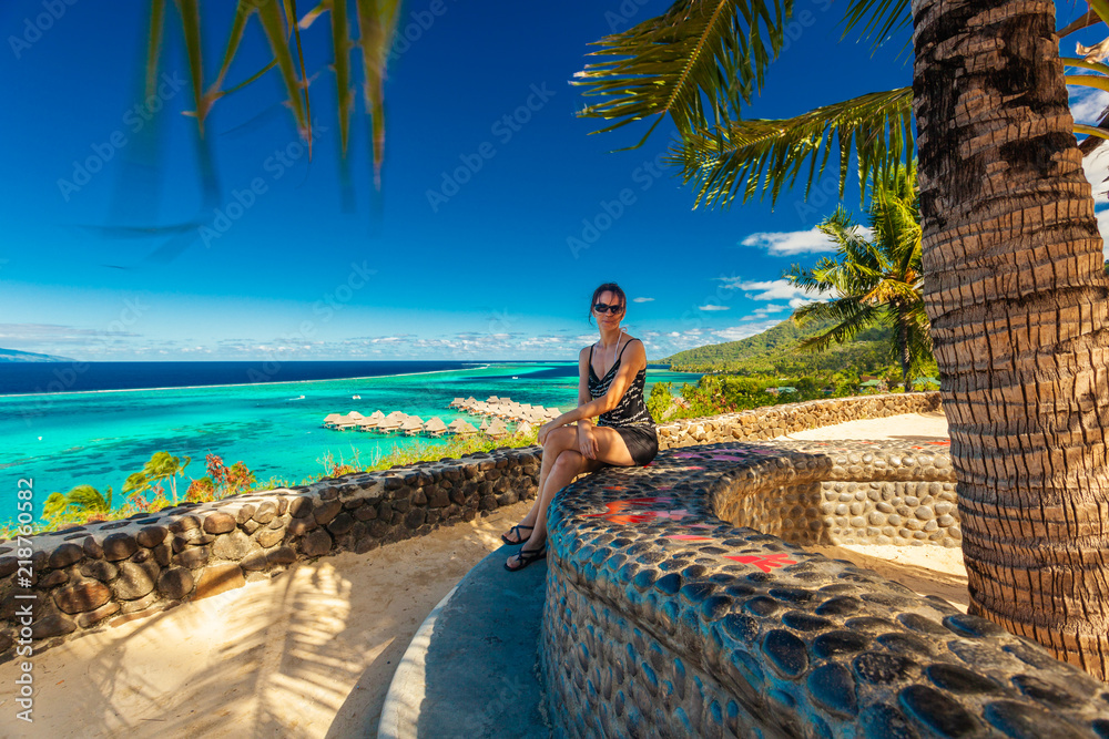 Young woman enjoying tropical beach holidays at Moorea, French Polynesia