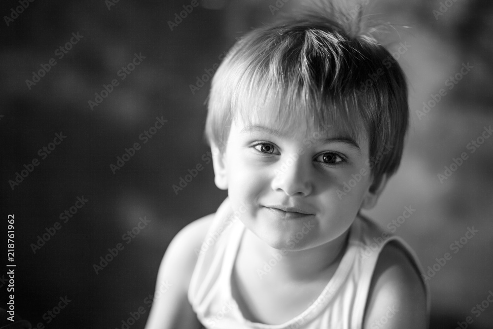 Portrait of the little boy. Smiling boy 3-4 years looking at the camera. Emotional portrait close up. Black-and-white image Portrait of the little boy. Smiling boy 3-4 years looking at the camera. Emotional portrait close up. Black-and-white image