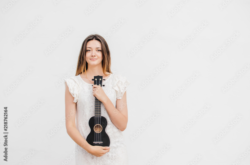 Tyr filter krysantemum Young smiling beautiful woman with ukulele Stock Photo | Adobe Stock