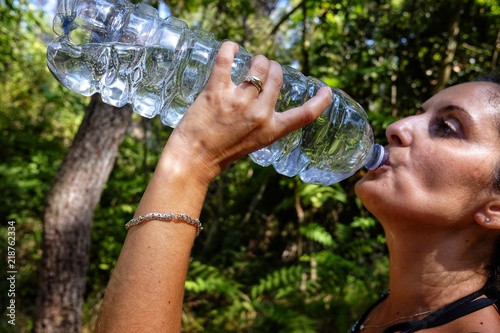 woman drinks water to the bottle