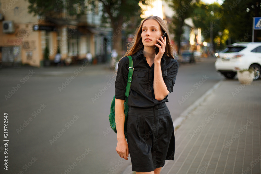young woman with credit card and smartphone in hand on the background of old city street young woman with credit card and smartphone in hand on the background of old city street
