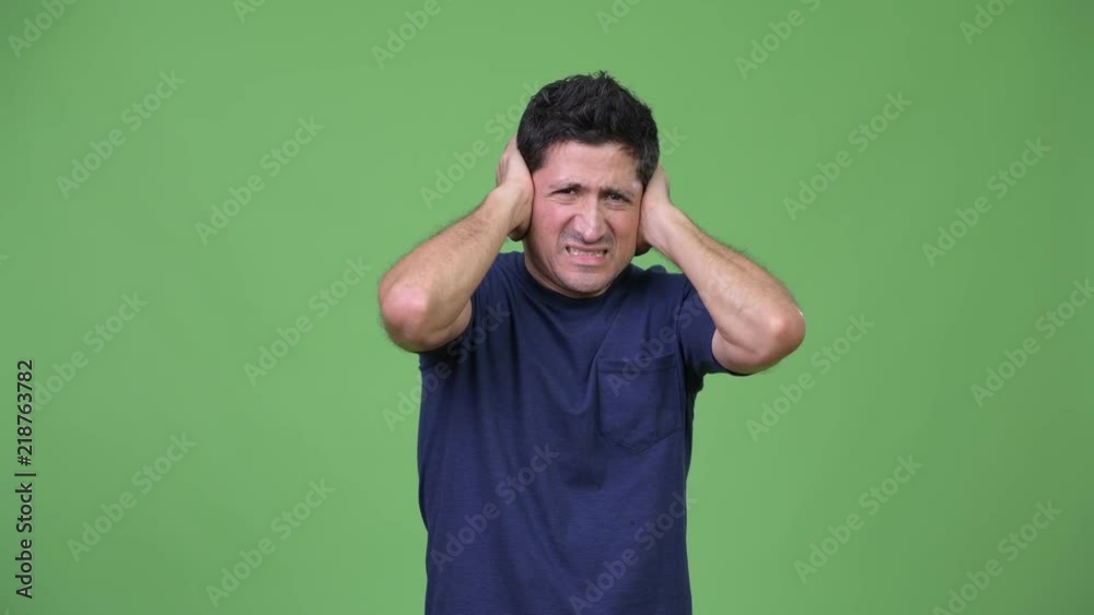 Stressed Hispanic man not wanting to hear something Stressed Hispanic man not wanting to hear something