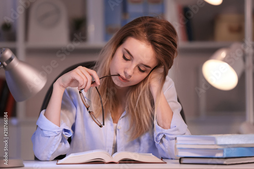 Young woman reading book at...
