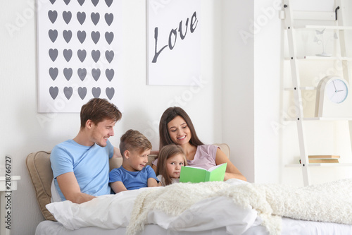 Happy family reading book t...