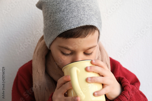 Cute little boy with cup of...