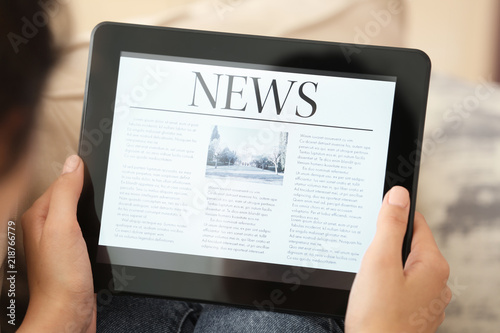 Woman reading news on table...