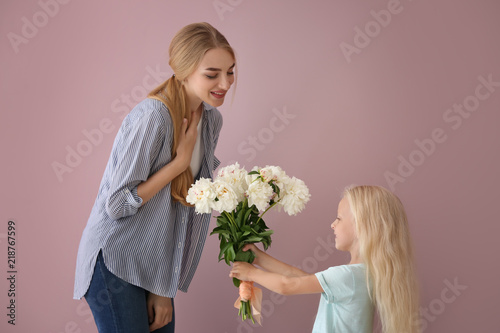 Cute little girl giving flo...