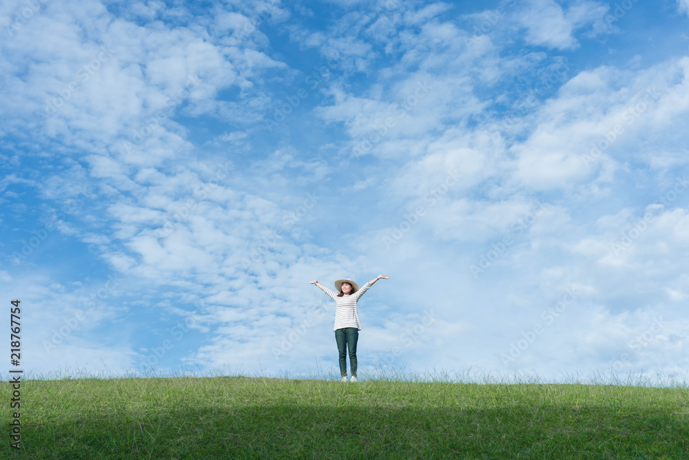 Standing woman raised her hands on the mountain, natural green and beautiful sky. Standing woman raised her hands on the mountain, natural green and beautiful sky.