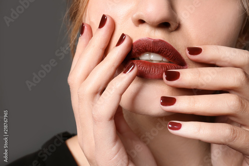 Fényképezés Fashionable young woman with beautiful manicure on grey background, closeup