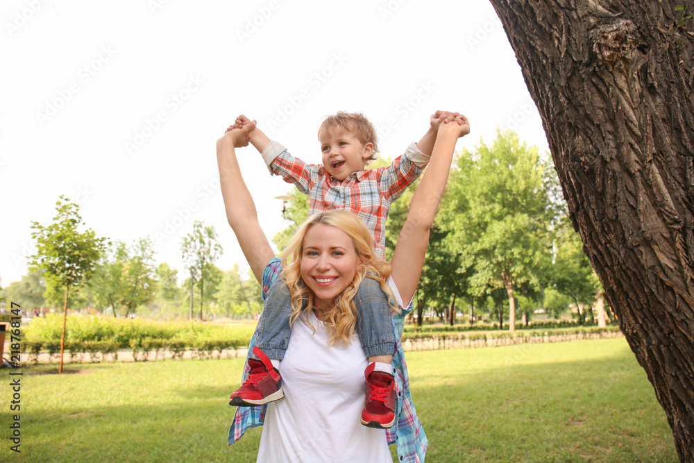 Fototapeta premium Happy mother with son in green park