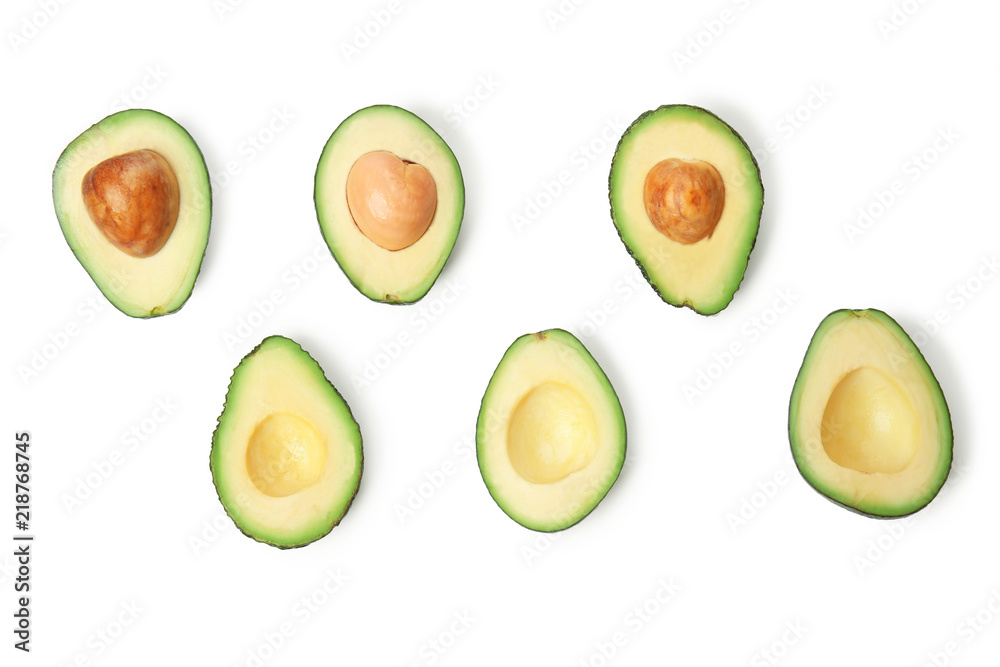 Halves of ripe avocados on white background, flat lay Halves of ripe avocados on white background, flat lay