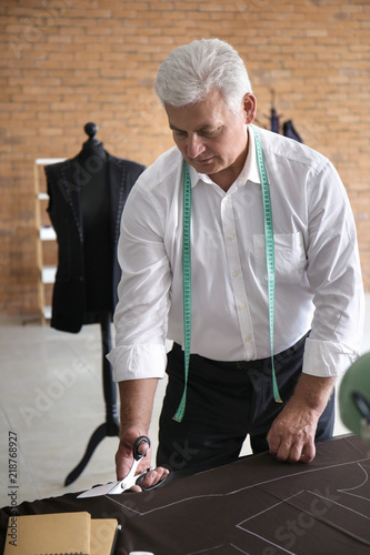Mature tailor cutting fabri...