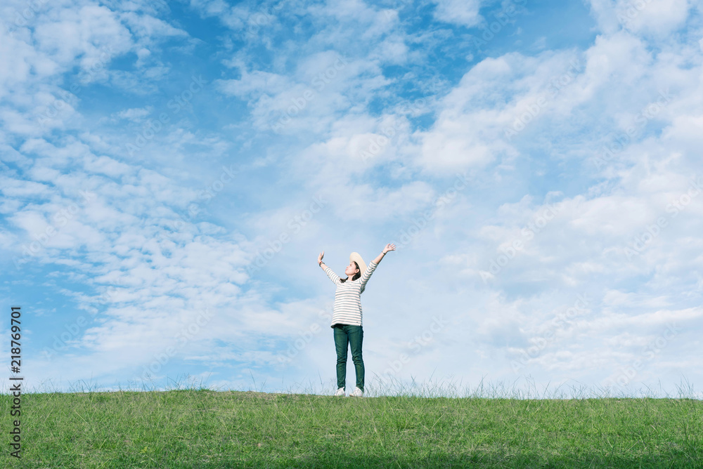 Standing woman raised her hands on the mountain, natural green and beautiful sky. Standing woman raised her hands on the mountain, natural green and beautiful sky.