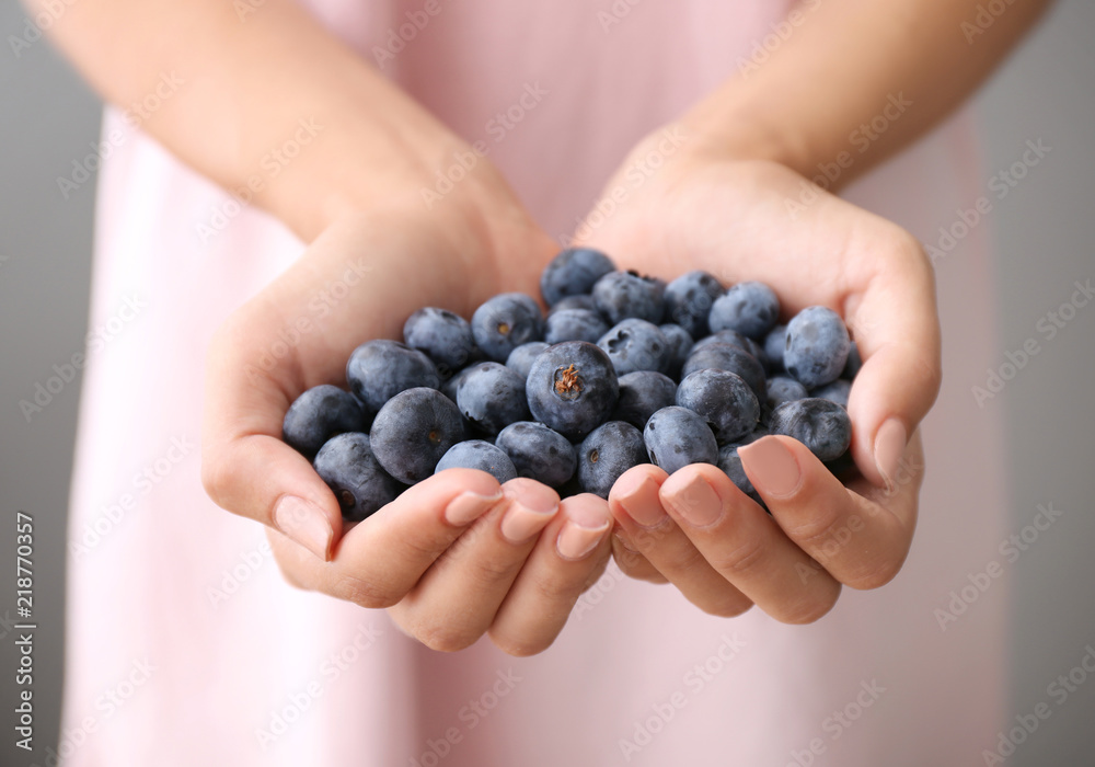Woman holding fresh ripe blueberries, closeup Woman holding fresh ripe blueberries, closeup