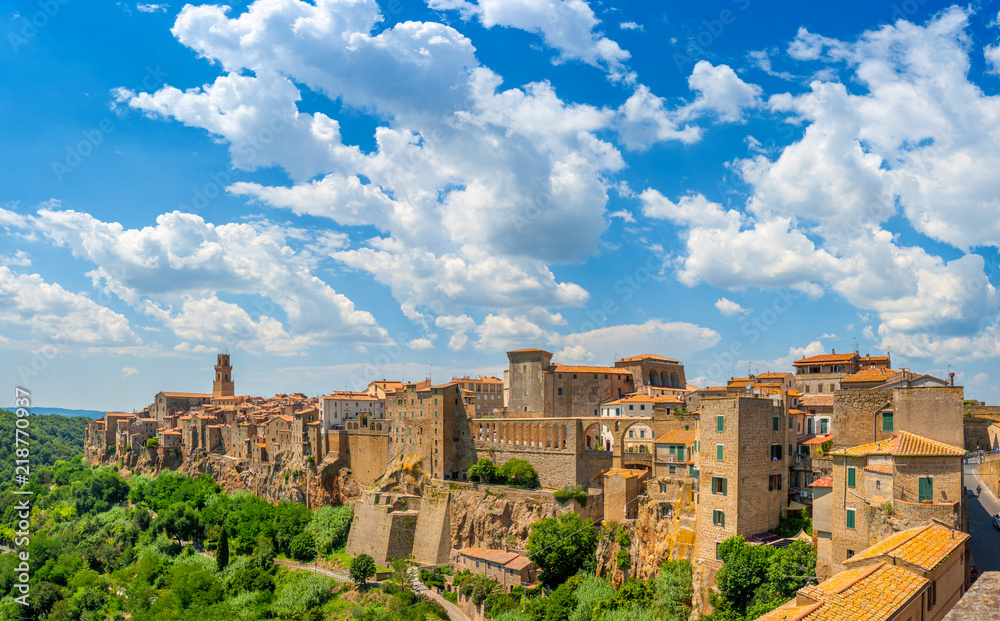 Panorama of the medieval town of Pitigliano located on the edge of the cliff, with beautiful clouds in the sky, Tuscany. Italy. Europe