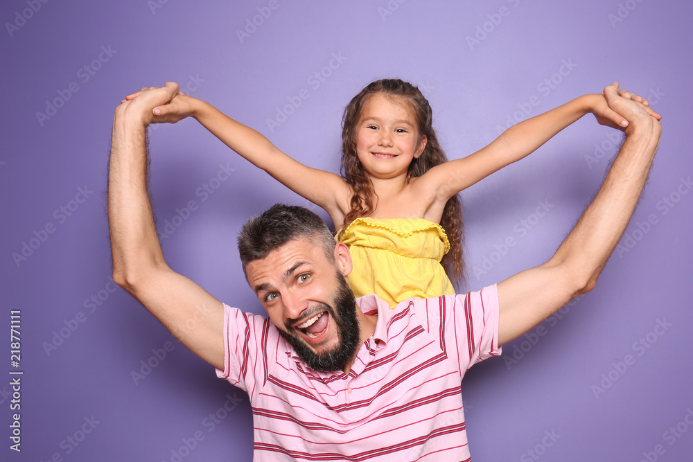 Funny portrait of father and his little daughter on color background Funny portrait of father and his little daughter on color background