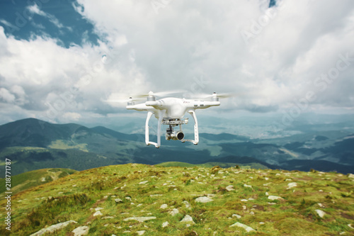 drone quadcopter with digital camera in the mountains