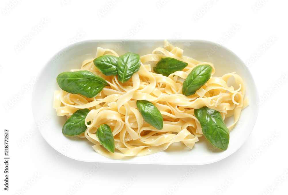 Plate of delicious pasta with basil on white background Plate of delicious pasta with basil on white background