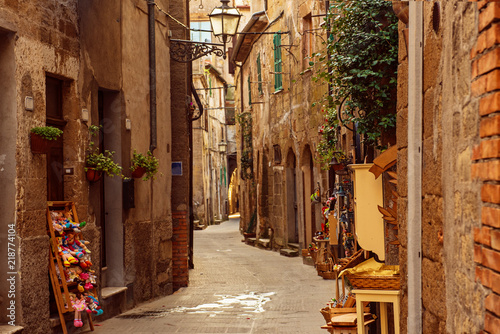 Fotografie Narrow street of medieval ancient tuff city Pitigliano, travel Italy background